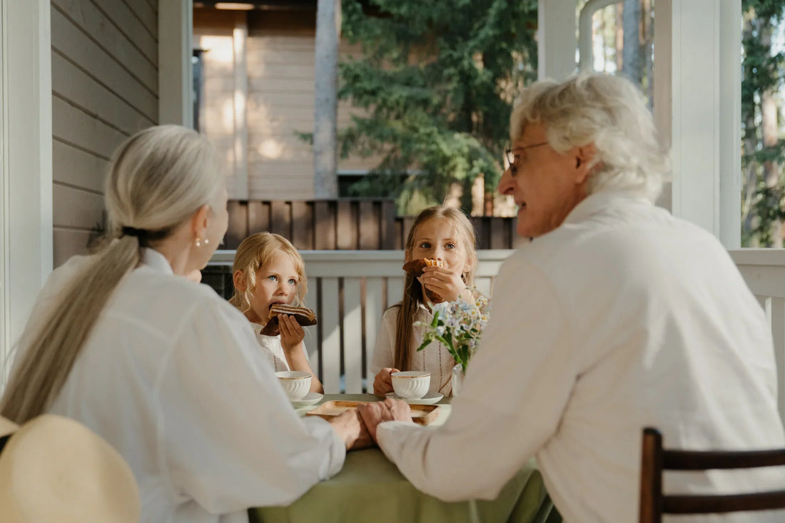 Grandparents enjoying dessert on the patio with 2 young girls