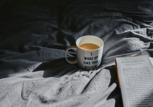 Why Am I Tired All the Time, Mug on a bed with a book